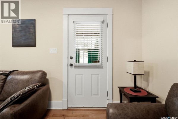 Interior view of a door with blinds, leading to the outside. - 2257 Elphinstone Street, Regina