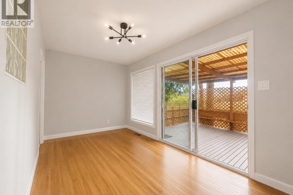 Covered wooden deck with outdoor furniture, plants, and lattice privacy screens. - 2259 Central Avenue, Port Coquitlam