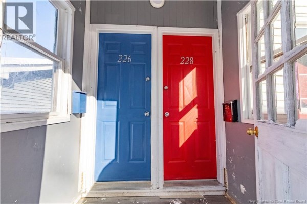 Two exterior doors, one blue labeled 226 and one red labeled 228, side by side. - 226-228 Watson Street, Saint John