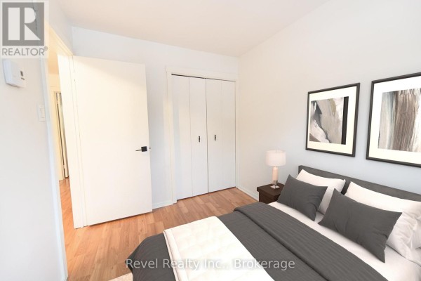Cozy living room with hardwood floors, fireplace, and access to outdoor deck - 227 - 17 Harbour Street W, Collingwood