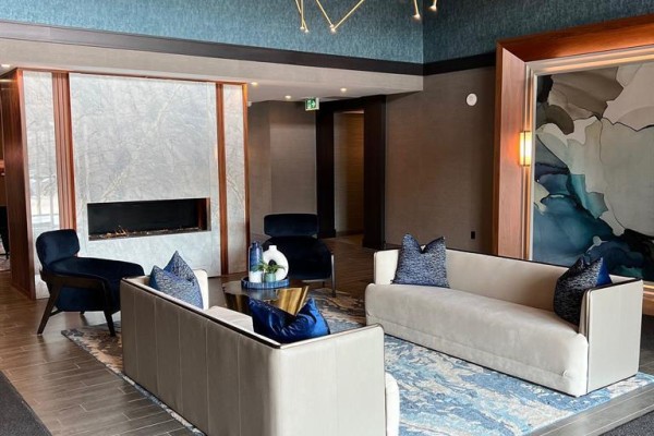 Lobby lounge area with fireplace, modern sofas, and abstract wall art. - 227 - 460 Dundas Street E, Hamilton