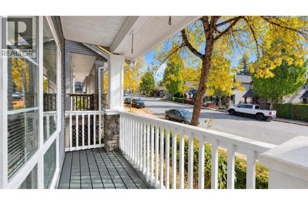 View from the covered porch looking down the street with parked cars and neighboring homes. - 22789 116 Avenue, Maple Ridge