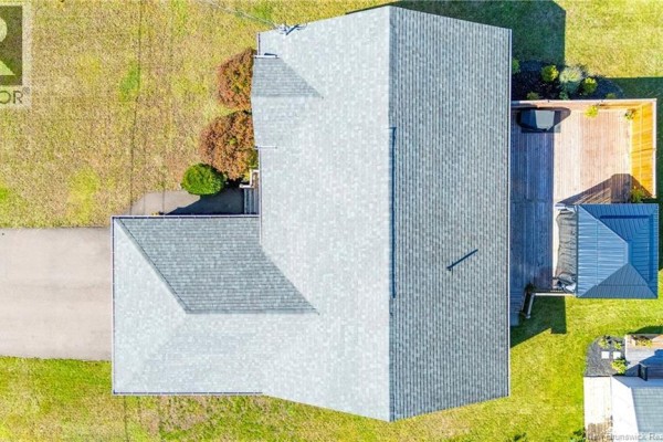 Aerial view of the house roof and backyard deck with a hot tub and shed. - 228 Herve Street, Dieppe