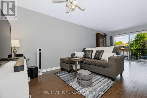 Interior view of a staircase with dark wood steps and grey walls, leading to the main floor. - 229 Britannia Avenue, Bradford West Gwillimbury