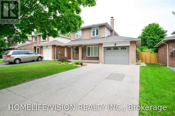 Exterior view of the house from the driveway, showing the garage, front entrance, and lawn. - 229 Village Wood Road, Oakville