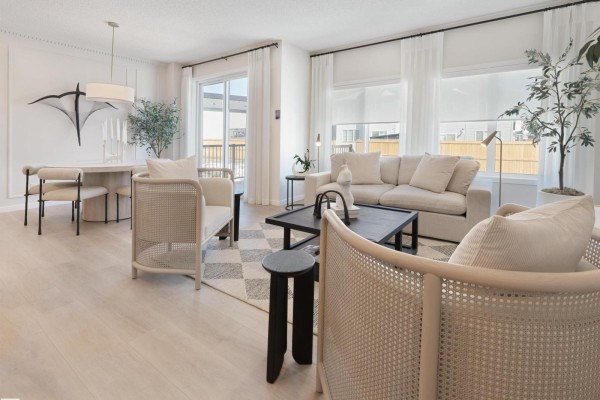 Modern kitchen with white shaker cabinets, stainless steel appliances, and a large island with pendant lighting. - 22926 93a Av Nw, Edmonton