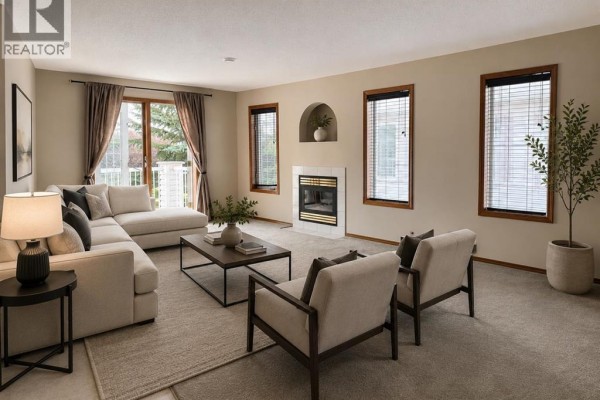 Kitchen and dining area featuring a breakfast bar, tile flooring, wooden chairs, and a large cabinet. - 22d, 32 Daines Avenue, Red Deer