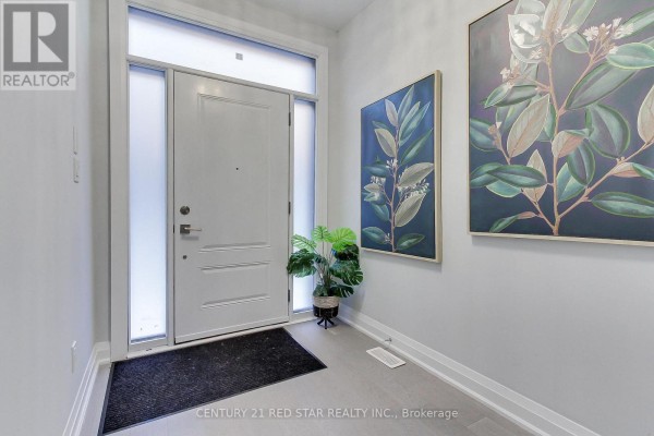 Bright foyer with white door, large windows, and decorative plant - 23 - 260 Eagle Street, Newmarket