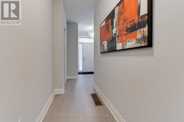Long hallway with light gray walls, artwork, and view of front door - 23 - 260 Eagle Street, Newmarket