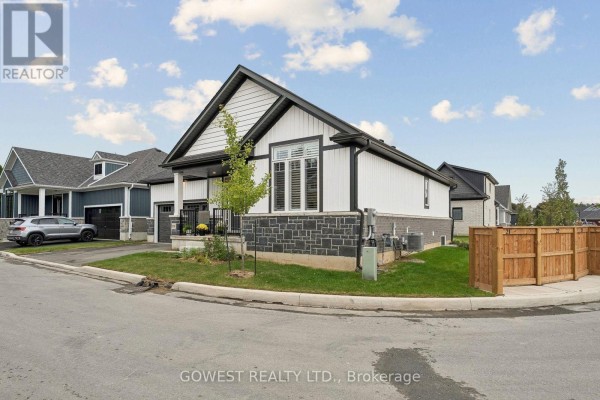 Right side view of a modern white house with black trim and a wooden fence in the backyard. - 23 - 2797 Red Maple Avenue, Lincoln
