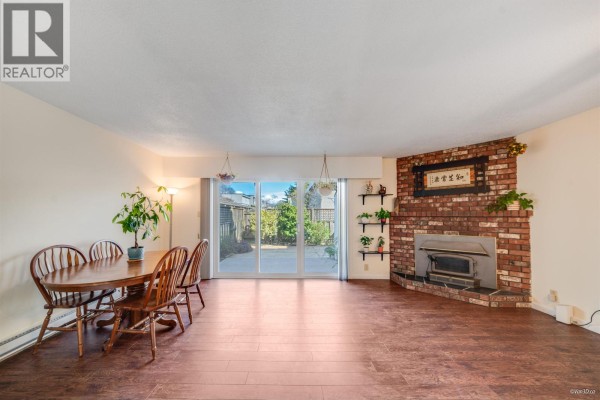 Dining area with wooden table, plants, and access to outdoor space - 23 10840 Springmont Drive, Richmond
