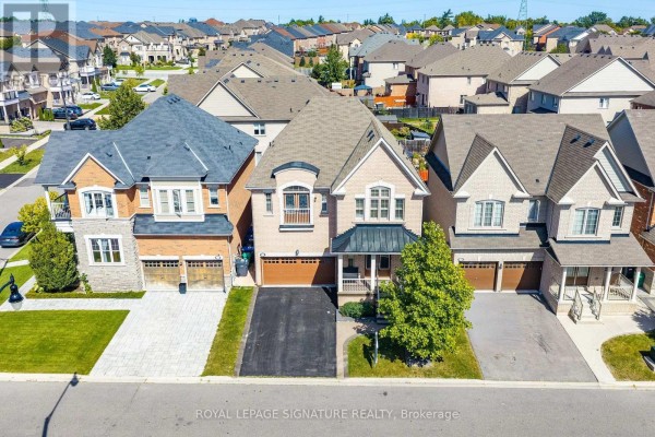 Aerial view of a suburban street with multiple houses and manicured lawns. - 23 Arrowpoint Drive, Brampton