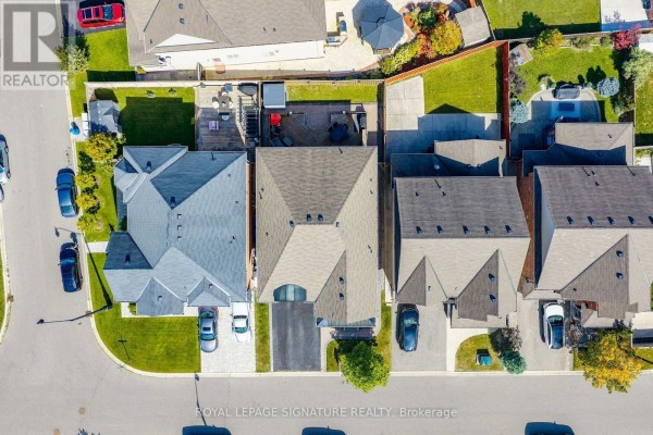 Overhead view of houses on a street, showing rooftops and backyards. - 23 Arrowpoint Drive, Brampton
