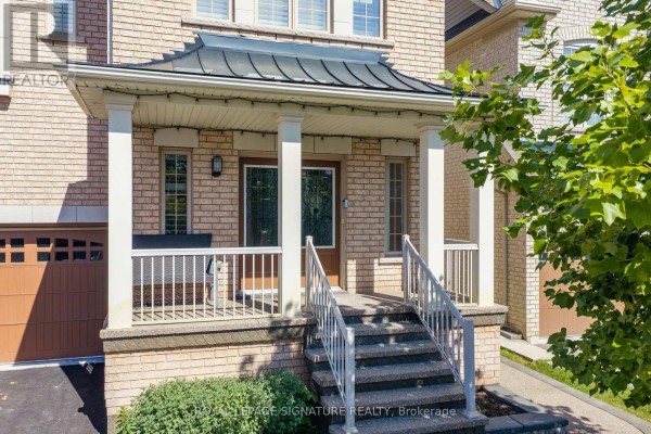 Close-up of the covered porch entrance with brick facade and stairs. - 23 Arrowpoint Drive, Brampton