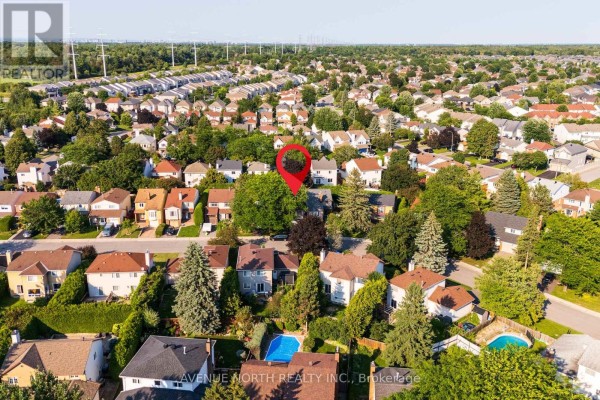 Aerial view of suburban neighborhood with houses, trees, and green spaces, marking the property location. - 23 Bluegrass Drive, Ottawa