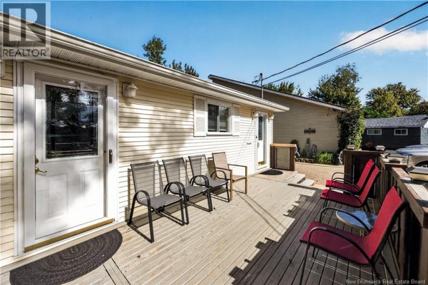 Wooden deck with red and grey chairs, accessible from two doors. - 23 Clover Lane, Pointe Du Chene