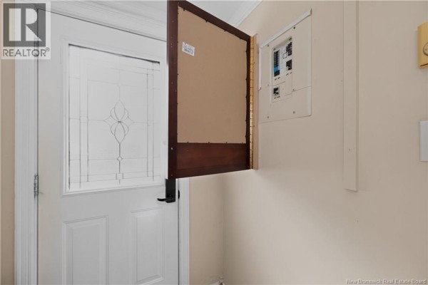 Interior view of a closed electrical panel and a frosted glass front door. - 23 Clover Lane, Pointe Du Chene