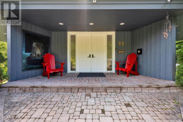 Dining area with a white table, colorful chairs, and large windows. - 23 Country Club Lane, Oro Medonte