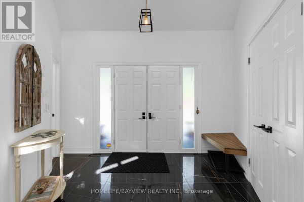 Octagonal ceiling with windows and a modern chandelier in a bright room. - 23 Country Club Lane, Oro Medonte