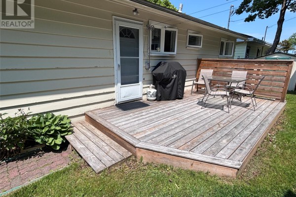 Aerial view of a green backyard with a wooden deck and a white shed. - 23 Diana Road, St  John S