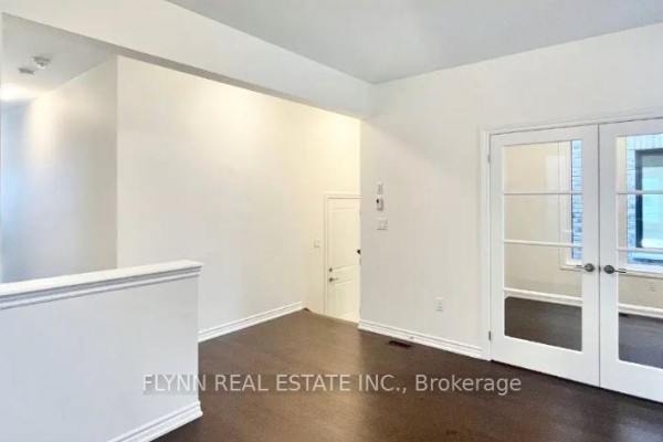 Room with white paneled double doors leading to another space and a door to a closet. - 23 Gemini Drive, Barrie