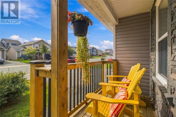 Front porch with yellow Adirondack chairs, a hanging plant, and a view of the street. - 23 Hollyberry Drive, Paradise