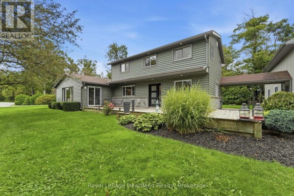 Front view of a green two-story house with a two-car garage on the right. - 23 Park Road, Central Huron
