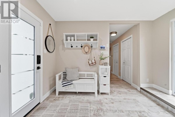 Interior view of the home's entryway, showing a modern white front door with frosted glass panels. - 23 Park Road, Central Huron
