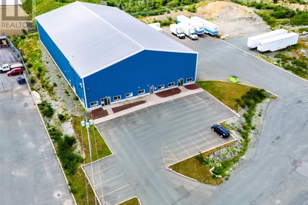 Aerial view of a large blue industrial warehouse with a silver metal roof. - 23 Pollard Avenue, Paradise