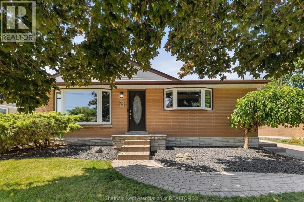 View of the front entrance with brick facade and manicured landscaping. - 23 Queensway Drive, Chatham