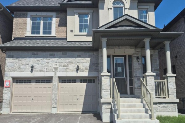 Front elevation of a modern home with a stone base, beige stucco, and dark roof. - 23 Rogerson Street, Clarington