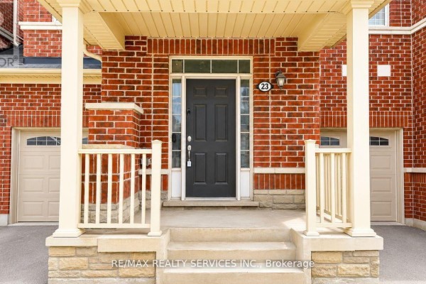 Close-up view of the front entrance door with address number 23, flanked by brick pillars. - 23 Sail Road, Brampton