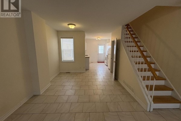 View from living room into dining area, kitchen, and staircase. - 230 Cumberland Street, Ottawa