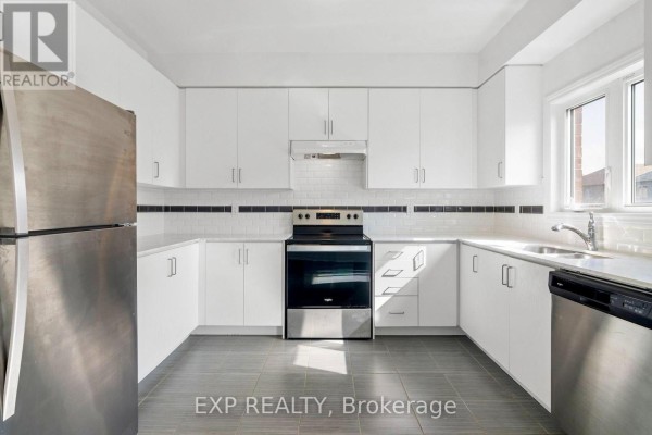 U-shaped kitchen with white cabinets, stainless steel appliances, and a window above the sink. - 230 Ridley Crescent, Southgate
