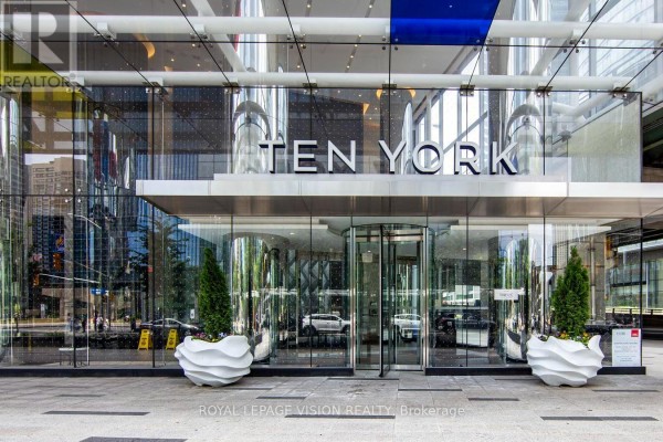The modern glass entrance to the "TEN YORK" building features a revolving door. - 2301 - 10 York Street, Toronto