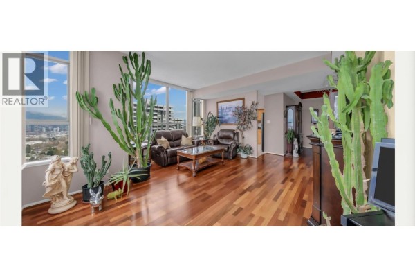 Balcony with glass railing, table, chairs, and panoramic city and mountain views. - 2301 5885 Olive Avenue, Burnaby