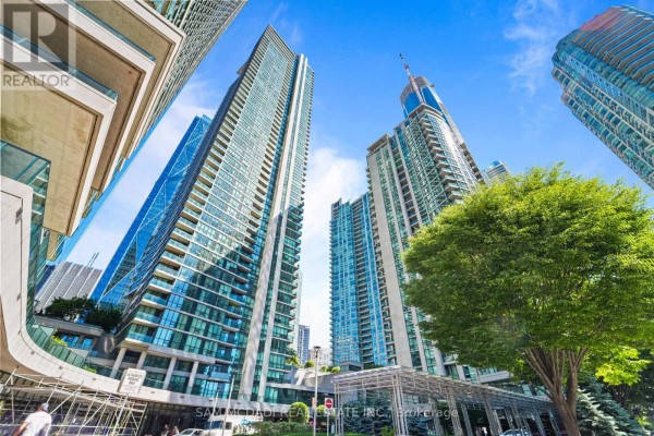 Low angle shot of modern apartment buildings with reflective glass facades. - 2304 - 18 Harbour Street, Toronto