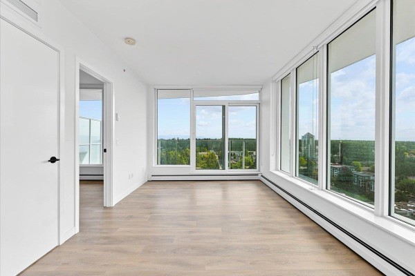 Bright room with large windows, hardwood flooring, and scenic views - 2305 13685 102 Avenue, Surrey