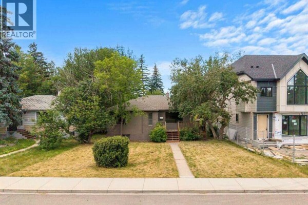 Aerial view of the property at 2307 Richmond Road Sw, Calgary, showing the house and surrounding buildings. - 2307 Richmond Road Sw, Calgary