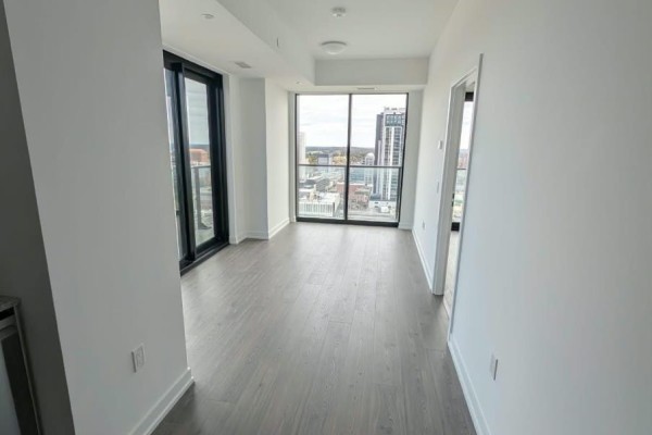 Apartment door number 2308 with a dark wood finish and a modern digital lock. - 2308 - 30 Francis Street, Kitchener