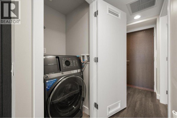 Laundry area with stacked washer and dryer in a compact space. - 2308 2008 Rosser Avenue, Burnaby