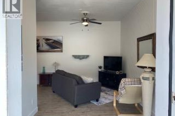 Small room with white walls, a white sink, and a mirror reflecting a narrow hallway. - 231 Finlayson Street, Sicamous