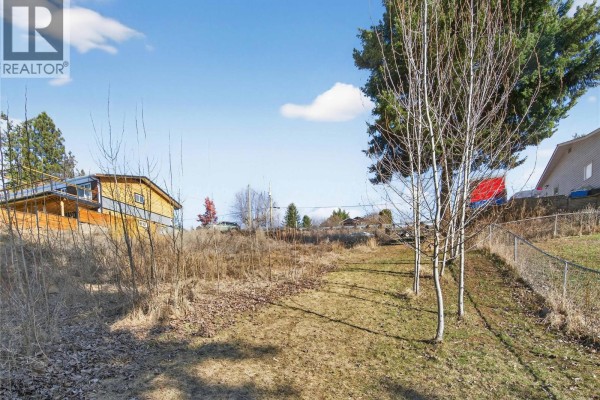 Panoramic view of the lake and surrounding residential area with mountains. - 2311 28 Street, Salmon Arm