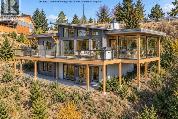 Aerial perspective of wooded lot with nearby homes and lake view. - 2311 28 Street, Salmon Arm