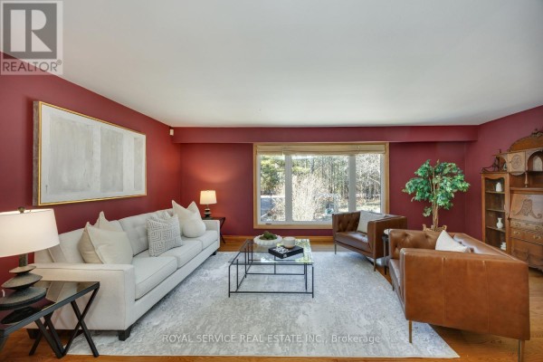 Living room with sofa, leather chairs, fireplace & large window - 2311 Division Street N Hamilton Township