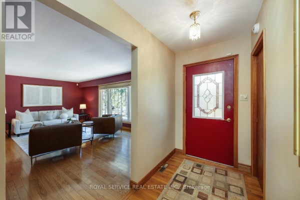 Hallway with red door and living room view - 2311 Division Street N Hamilton Township