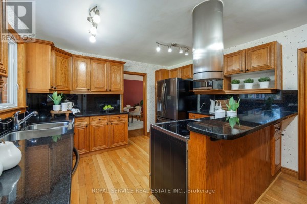 Kitchen with oak cabinets, granite counters, stainless steel appliances, and island - 2311 Division Street N Hamilton Township