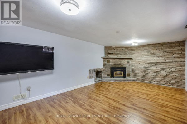 Living room with stone fireplace and TV - 2311 Division Street N Hamilton Township