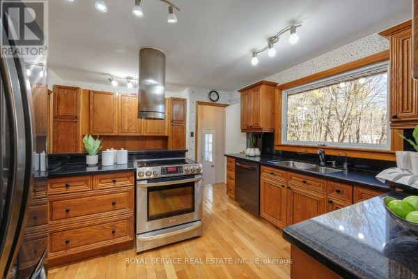 Kitchen with wood cabinets, granite counters, stainless steel range and range hood - 2311 Division Street N Hamilton Township