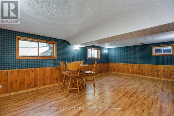 Basement with plaid wallpaper, wood paneling, and dining set - 2311 Division Street N Hamilton Township